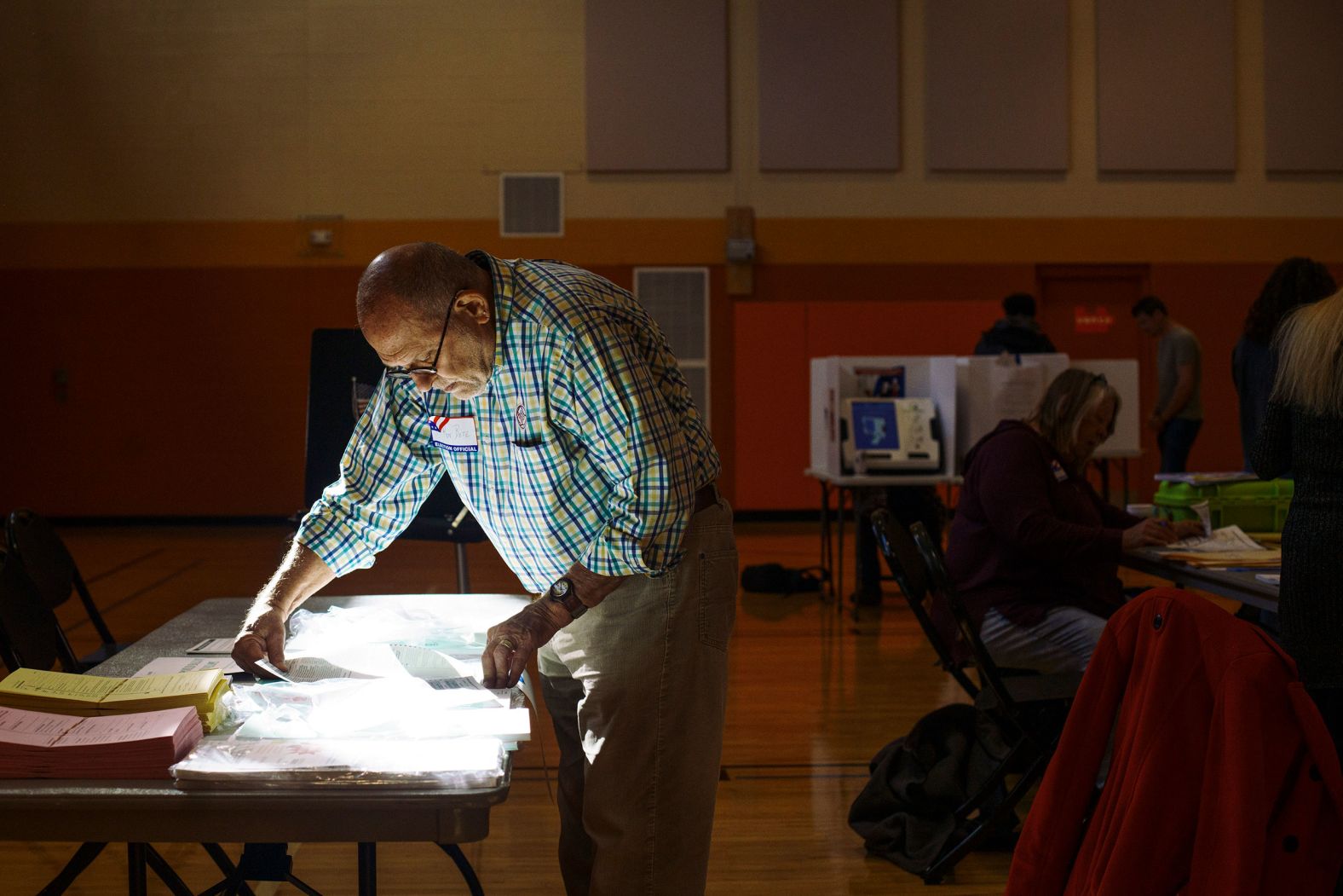 Poll worker Ron Betz grabs a provisional ballot for a voter at a polling location in Columbus, Ohio.