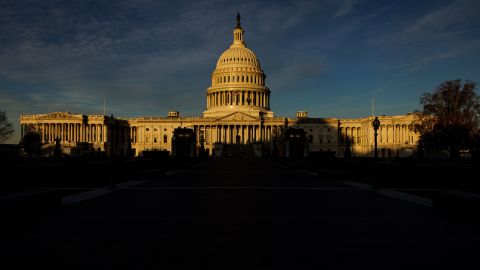 The rising sun creeps across the US Capitol dome on November 8, 2022, in Washington.