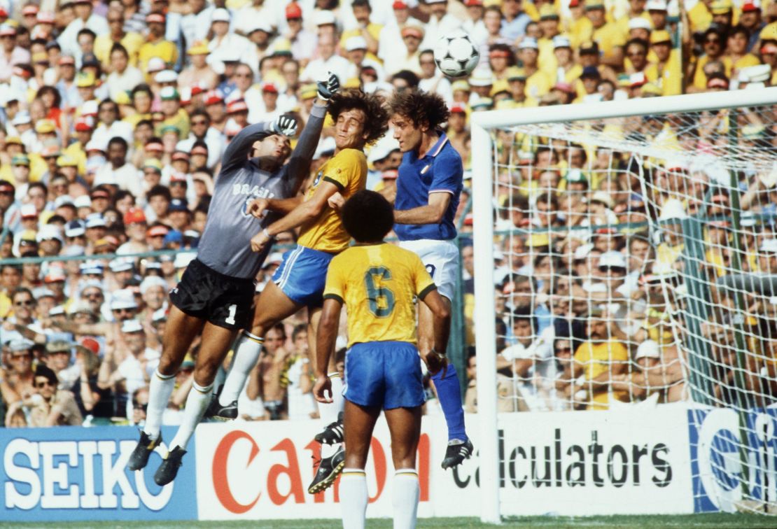 Italian forward Francesco Graziani tries to get to the ball with his head, but Brazil's goalkeeper Valdir Peres, assisted by his defender Oscar, punches the ball away.