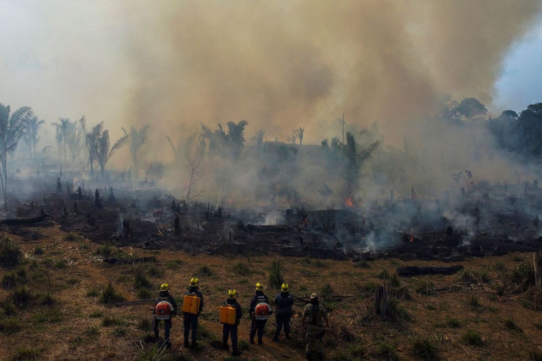 Firefighters and volunteers combat a fire on the Amazonia rainforest in Apui, southern Amazonas State, Brazil, on September 21, 2022.