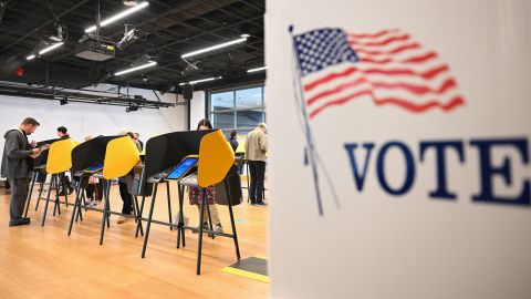 People cast ballots on electronic voting machines for the midterm election during early voting ahead of Election Day inside a vote center at the Hammer Museum in Los Angeles, California on November 7, 2022.