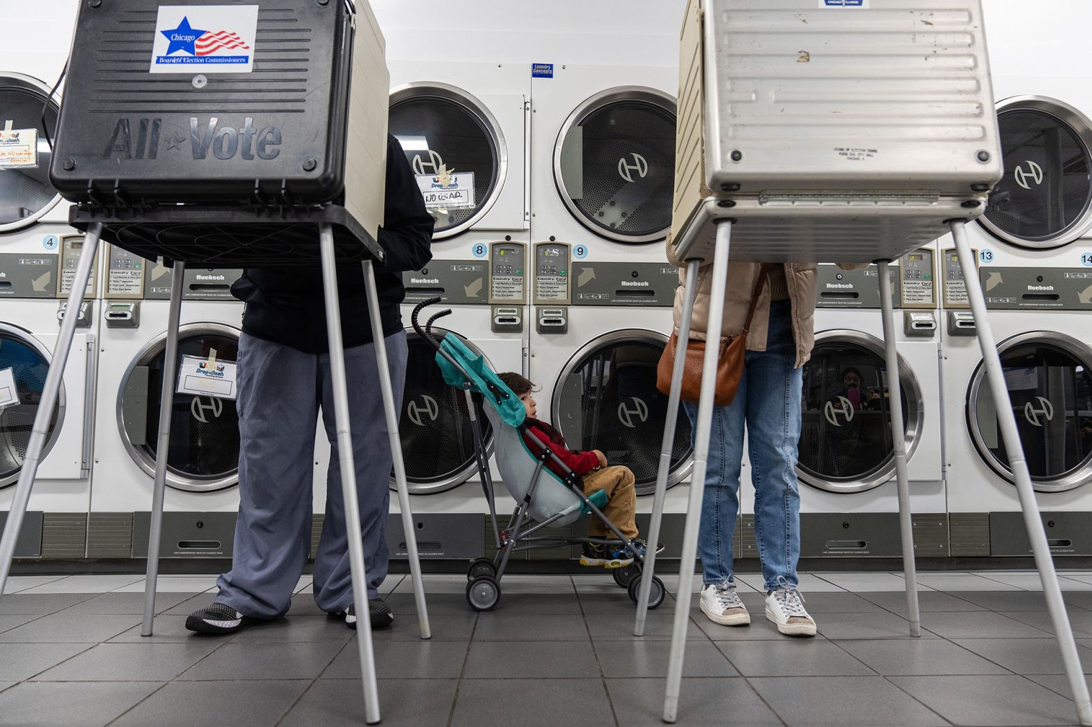 Zachary Valles-Perez waits as his parents, Antonio Perez and Christina Valle-Perez, vote at a laundromat in Chicago on Election Day.