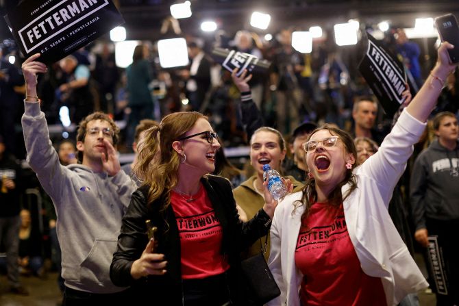 Supporters of Fetterman and Josh Shapiro, the Democratic gubernatorial candidate in Pennsylvania, react in Pittsburgh as they watch news of <a  target="_blank">Shapiro's projected victory.</a> 