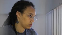 Brittney Griner stands inside a defendants' cage before the verdict in a court hearing in Khimki outside Moscow on August 4, 2022.