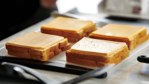 Grilled cheese sandwiches are prepared with Kraft Heinz NotCo American Style plant-based cheese slices.