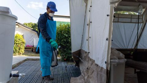A worker disinfects around a clinic run by Doctors Without Borders in Cité Soleil, Port-au-Prince, Haiti, October 7, 2022.