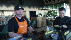 Wayne Rooney rolls sushi with CNN's Becky Anderson in Dubai.