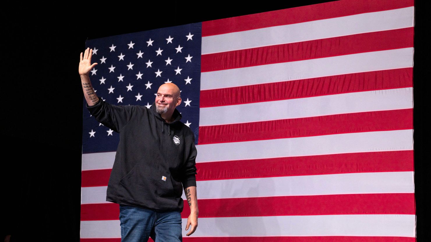 John Fetterman waves as he arrives onstage at a watch party during the midterm elections at Stage AE in Pittsburgh, Pennsylvania, on November 8, 2022. 