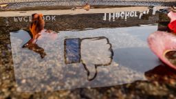 The Facebook logo reflected in a puddle at the company's headquarters in Menlo Park, California, U.S., on Monday, Oct. 25, 2021. 