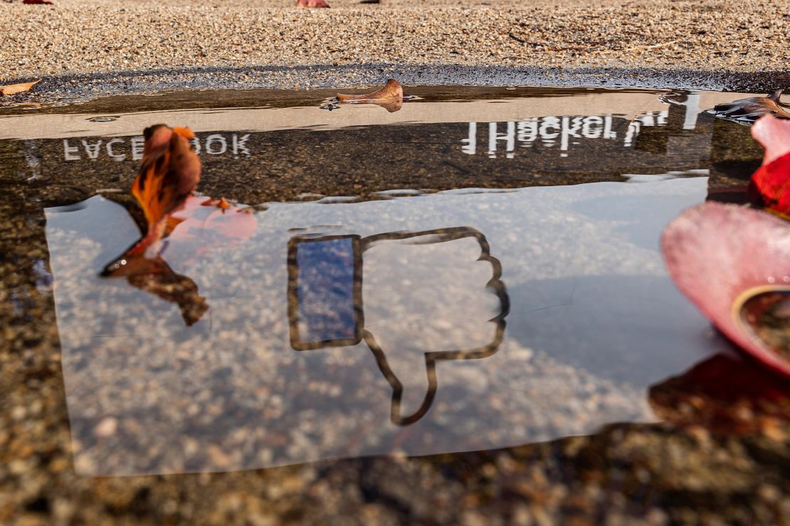 The Facebook logo reflected in a puddle at the company's headquarters in Menlo Park, California, U.S., on Monday, Oct. 25, 2021. 