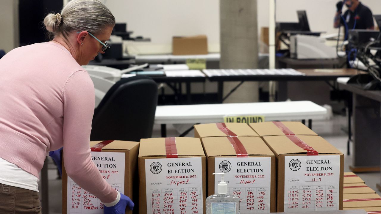 An election worker places a box of scanned ballots on a pallet at the Maricopa County Tabulation and Election Center on November 10, 2022, in Phoenix. 