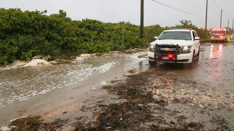 A road on Hutchinson Island in Martin County, Florida, is blocked Thursday by sand pushed in from Nicole's storm surge.