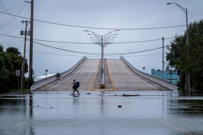 A man wades through a flooded street in Vero Beach, Florida, on Thursday.