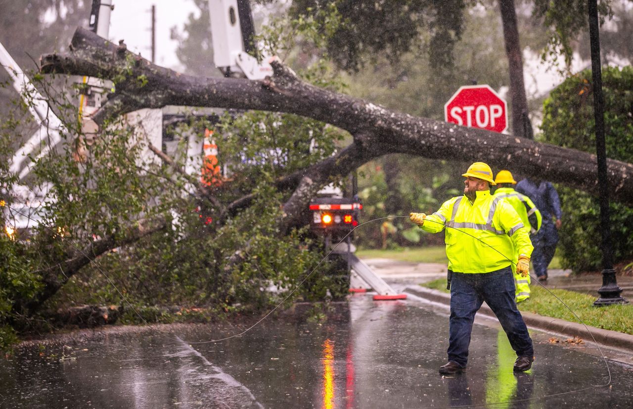 Workers try to restore power after a tree fell in Ocala, Florida, on Thursday.