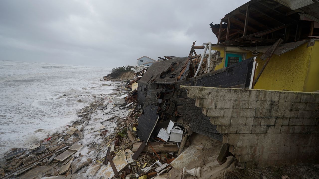 Homes are collapsing in Wilbur-By-The-Sea, Florida, on Thursday as Nicole's storm surge batters the coast.