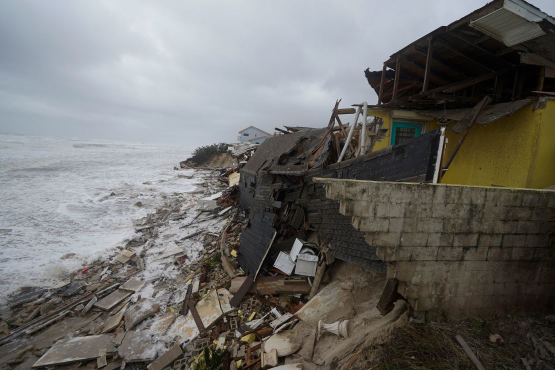 Homes are collapsing in Wilbur-By-The-Sea, Florida, on Thursday as Nicole's storm surge batters the coast.