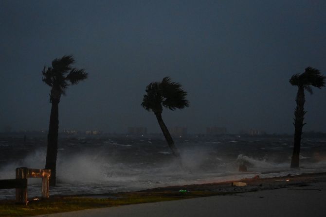 Palm trees are pounded by high tide and winds in Jensen Beach. 