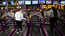 A customer cleans a treadmill while working out inside a Planet Fitness Inc. gym as the location reopens after being closed due to the Covid-19 pandemic, on March 16, 2021 in Inglewood, California. 