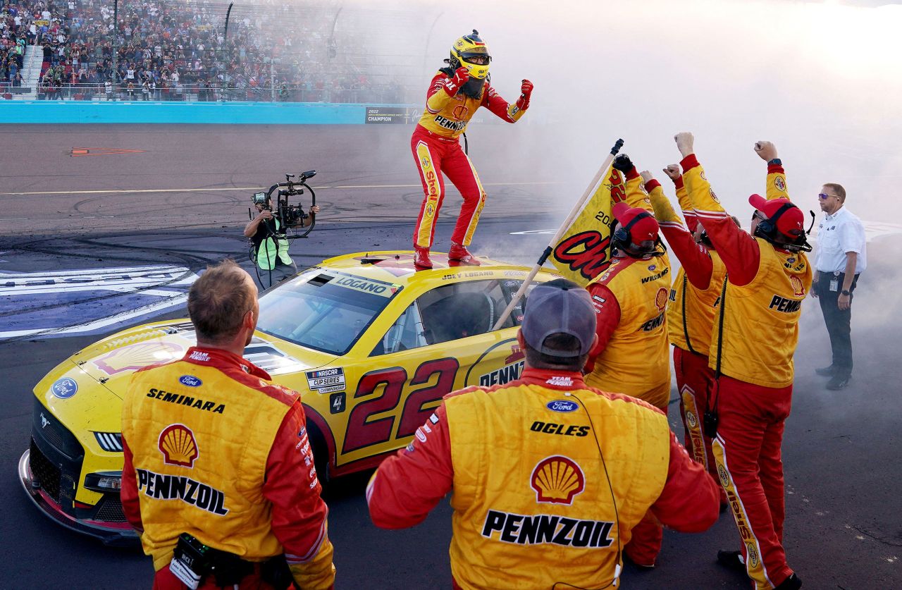 NASCAR driver Joey Logano celebrates with his crew after winning the Cup Series title in Avondale, Arizona, on Sunday, November 6. Logano also won the championship in 2018.