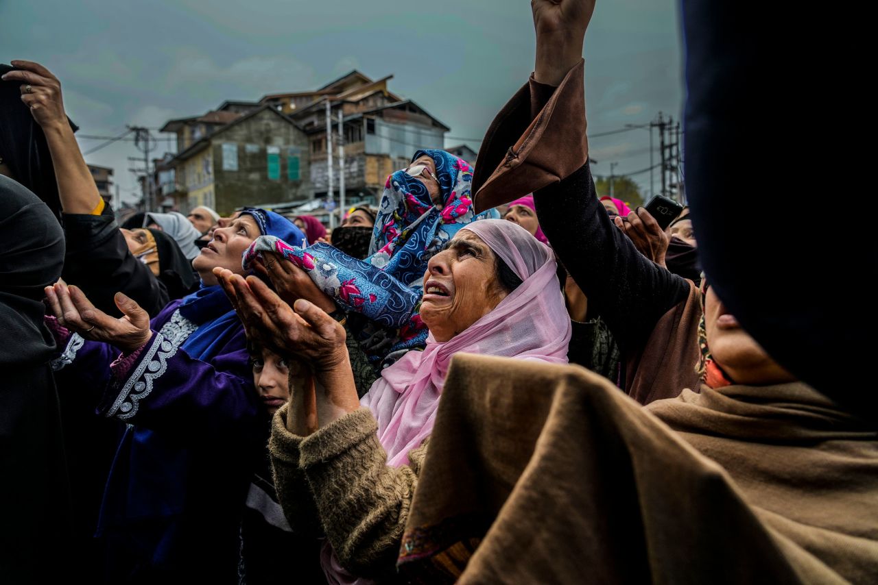 Kashmiri Muslim women weep while a priest displays a relic of Sufi saint Sheikh Syed Abdul Qadir Jeelani outside his shrine in Srinagar, India, on Monday, November 7.