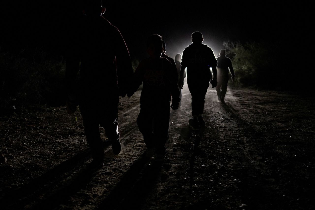 Central American migrants are followed by a US Border Patrol vehicle after crossing the Rio Grande into Texas on Wednesday, November 9.