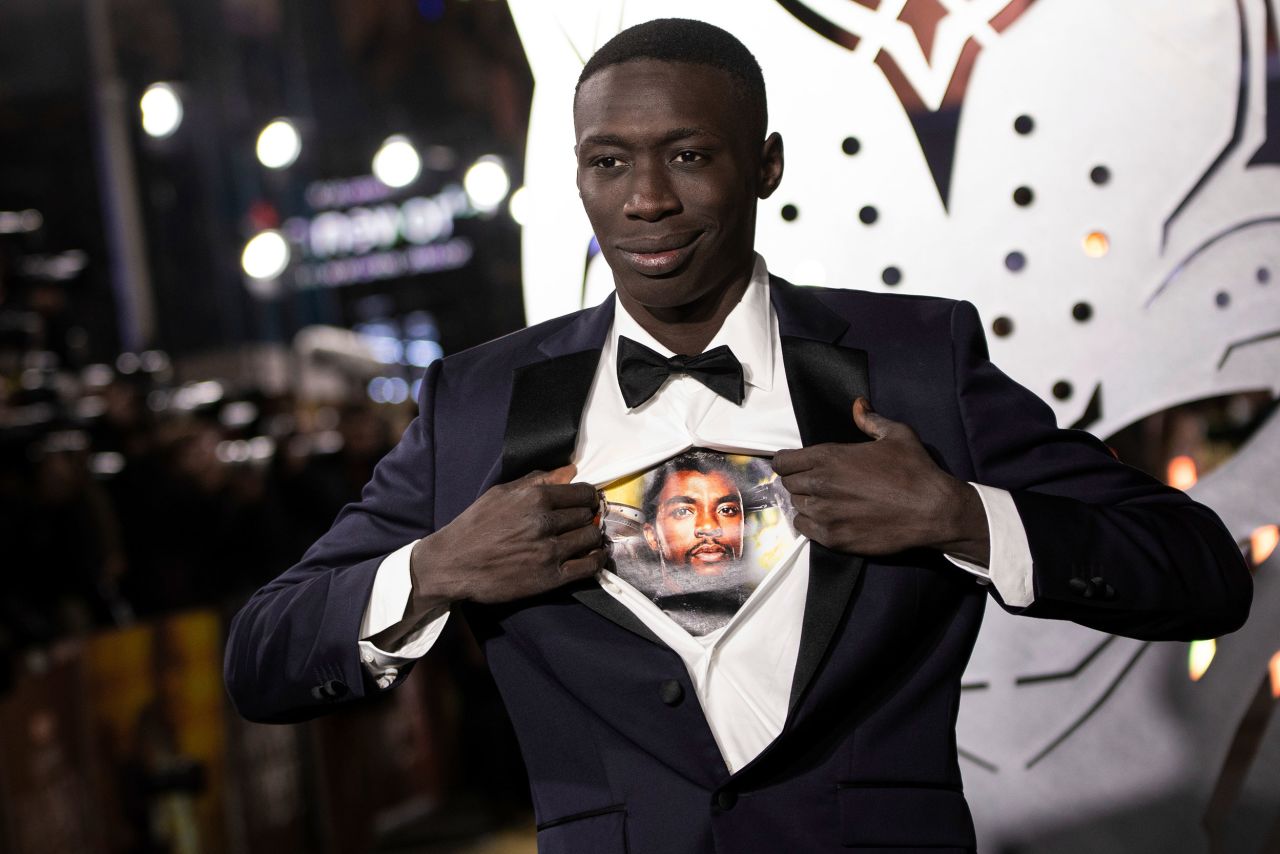 Comedian and <a href="https://www.cnn.com/2022/06/23/world/khaby-lame-most-followed-man-tiktok-cec/index.html" target="_blank">TikTok king</a> Khaby Lame opens his shirt to reveal an image of the late <a href="http://www.cnn.com/2020/08/29/entertainment/gallery/chadwick-boseman/index.html" target="_blank">Chadwick Boseman</a> as he attends the London premiere of the film "Black Panther: Wakanda Forever" on Thursday, November 3. Boseman, who starred in the first "Black Panther" movie, died in 2020.
