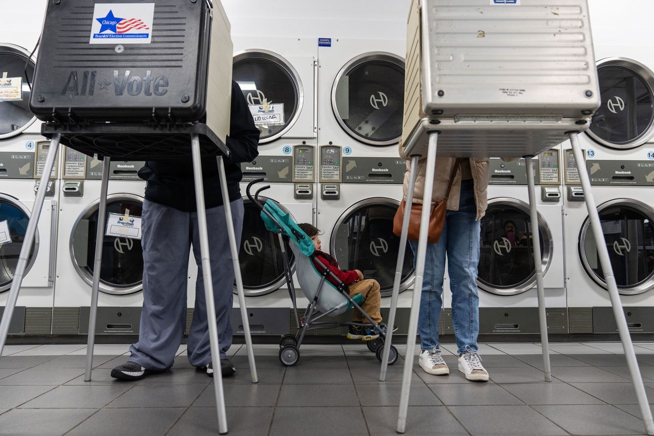 Zachary Valles-Perez waits as his parents, Antonio Perez and Christina Valle-Perez, vote at a laundromat in Chicago on Tuesday, November 8.