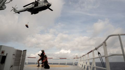 A migrant in need of urgent medical care is winched up on a stretcher by a helicopter of the French Army from the Ocean Viking rescue ship on November 10, 2022 in the Tyrrhenian Sea between Italy and Corsica island. 