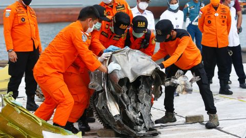 Rescue personnel with some of the wreckage of Sriwijaya Air flight SJ 182, which crashed into the Java Sea, at Tanjung Priok port in Jakarta, Indonesia, on January 19, 2021. 