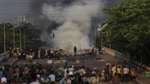 Protestors setup and guard makeshift barricades to block the road during the demonstration against the military coup in Yangon, Myanmar in March 2021. 