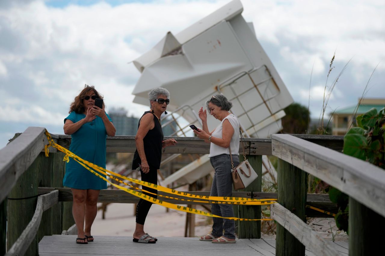 People in Vero Beach investigate storm damage, including a lifeguard station that was displaced on Thursday.