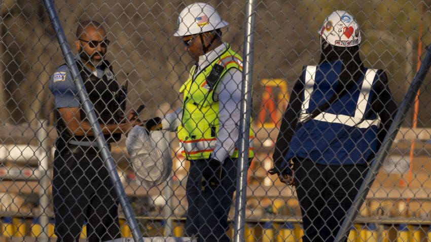 A Chicago police officer, left, takes a bag containing rope from the construction site of the Obama Presidential Center on Thursday, Nov. 10, 2022, in Chicago's Jackson Park neighborhood. Officials say a noose was discovered at the project site and construction has been halted. (Brian Cassella/Chicago Tribune/Tribune News Service via Getty Images)
