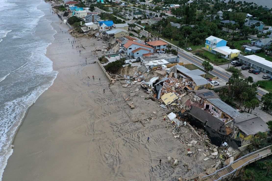 Homes are partially toppled Thursday onto Daytona Beach, Florida, after Hurricane Nicole made landfall.