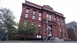 A cyclist rolls past the Peabody Museum of Archaeology & Ethnology at Harvard University in Cambridge, Massachusetts on October 13, 2016. The Peabody apologized Thursday for its "complicity" in the objectification of Native peoples. 