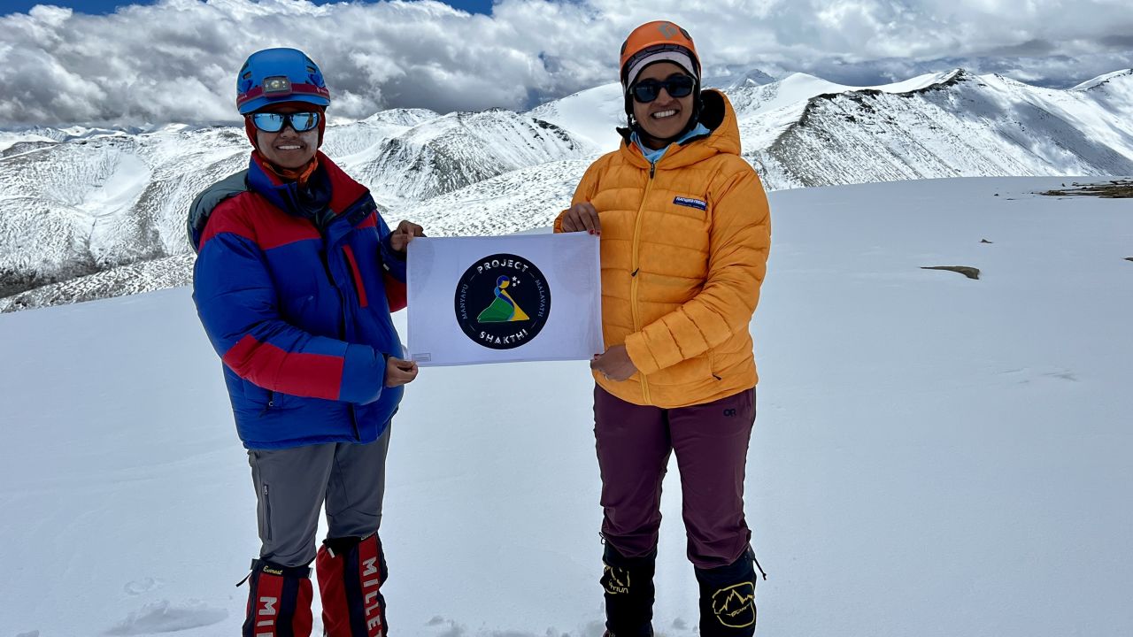 Malavath and Manyapu hold up their Project Shakthi logo at the summit.