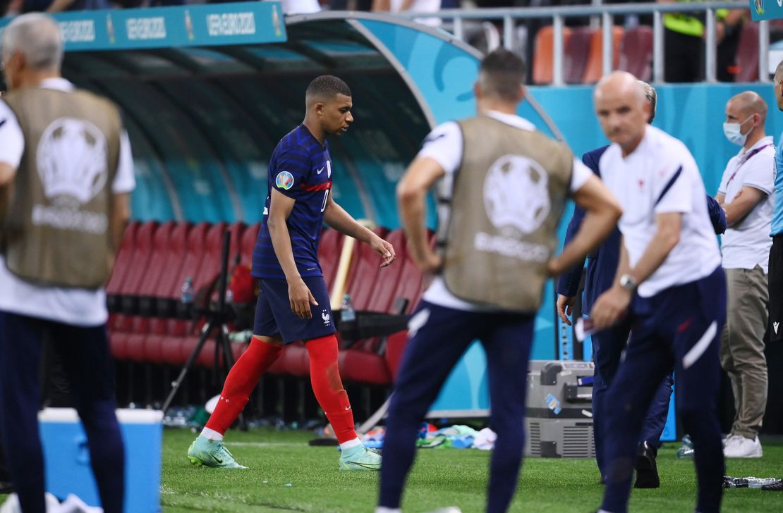 Mbappé looks dejected as he leaves the pitch after having his penalty saved in the shootout with Switzerland at Euro 2020. 