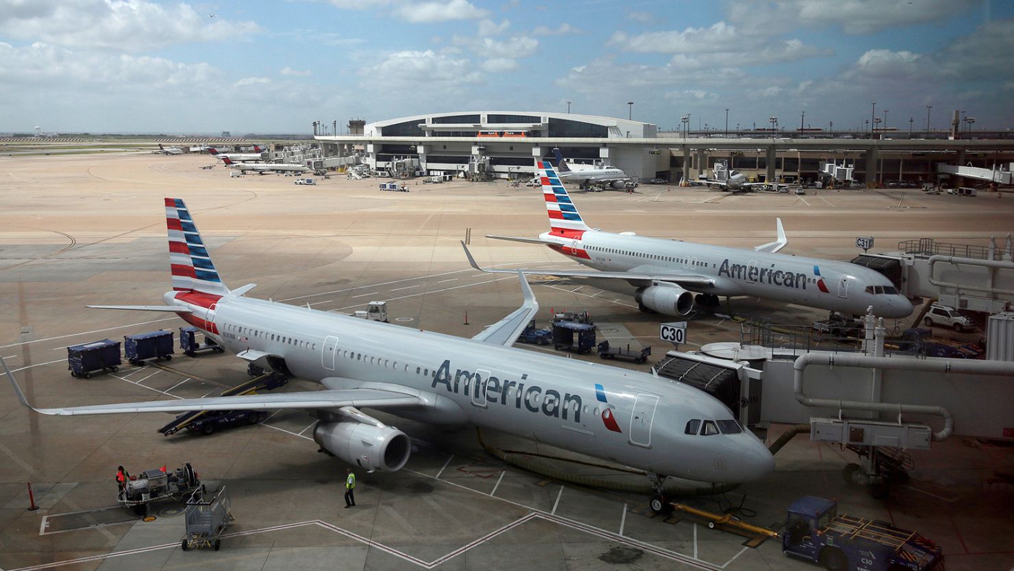 FILE - In this June 16, 2018, file photo, American Airlines aircrafts are seen at Dallas-Fort Worth International Airport in Grapevine, Texas. American Airlines is expanding at its most profitable airport, opening 15 new gates at Dallas-Fort Worth International. American said the gates that opened Friday, May 2, 2019, in Terminal E will let it add more than 100 daily flights on its American Eagle affiliate. (AP Photo/Kiichiro Sato, File)