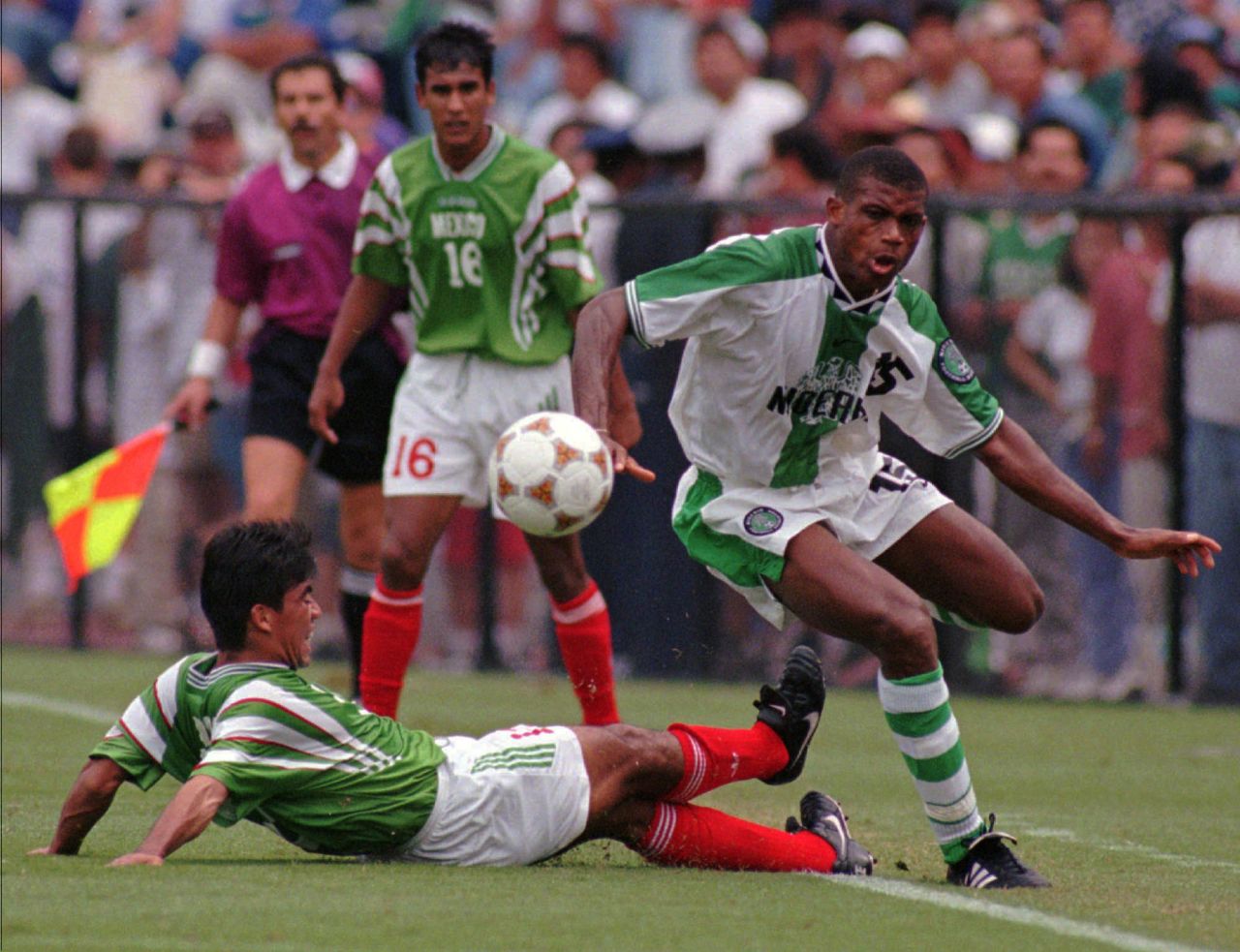 After beating Japan 2-0, and then losing to Brazil, Nigeria faced Mexico in the quarterfinals. Pictured, Sunday Oliseh dribbles around Mexico's Pavel Pardo en route to a 2-0 victory.