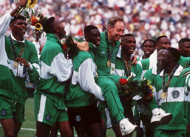 The players hold aloft coach Johannes Bonfrère. His tenure came after that of fellow Dutchman Clemens Westerhof, who  coached the Nigerian team that won the 1994 African Cup of Nations and was widely credited with laying the groundwork for the country's Olympic victory.