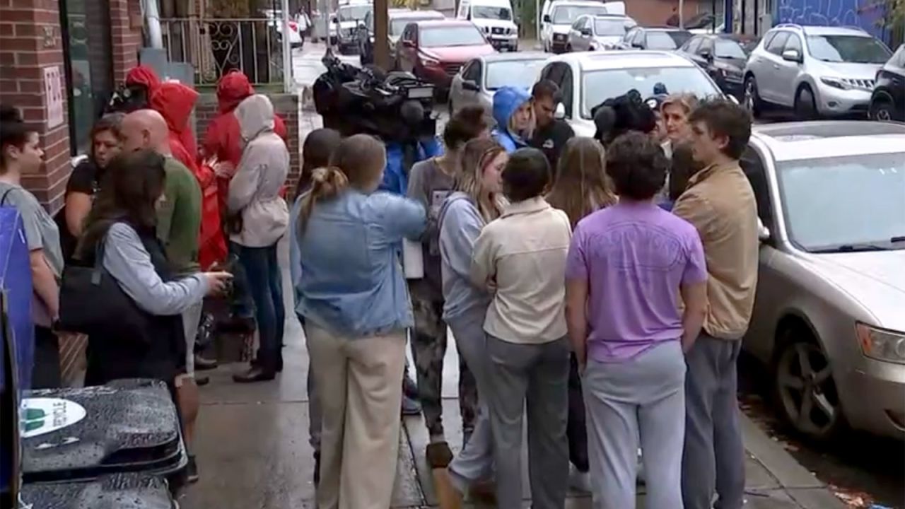 Temple University students return to their house after being interviewed by police.