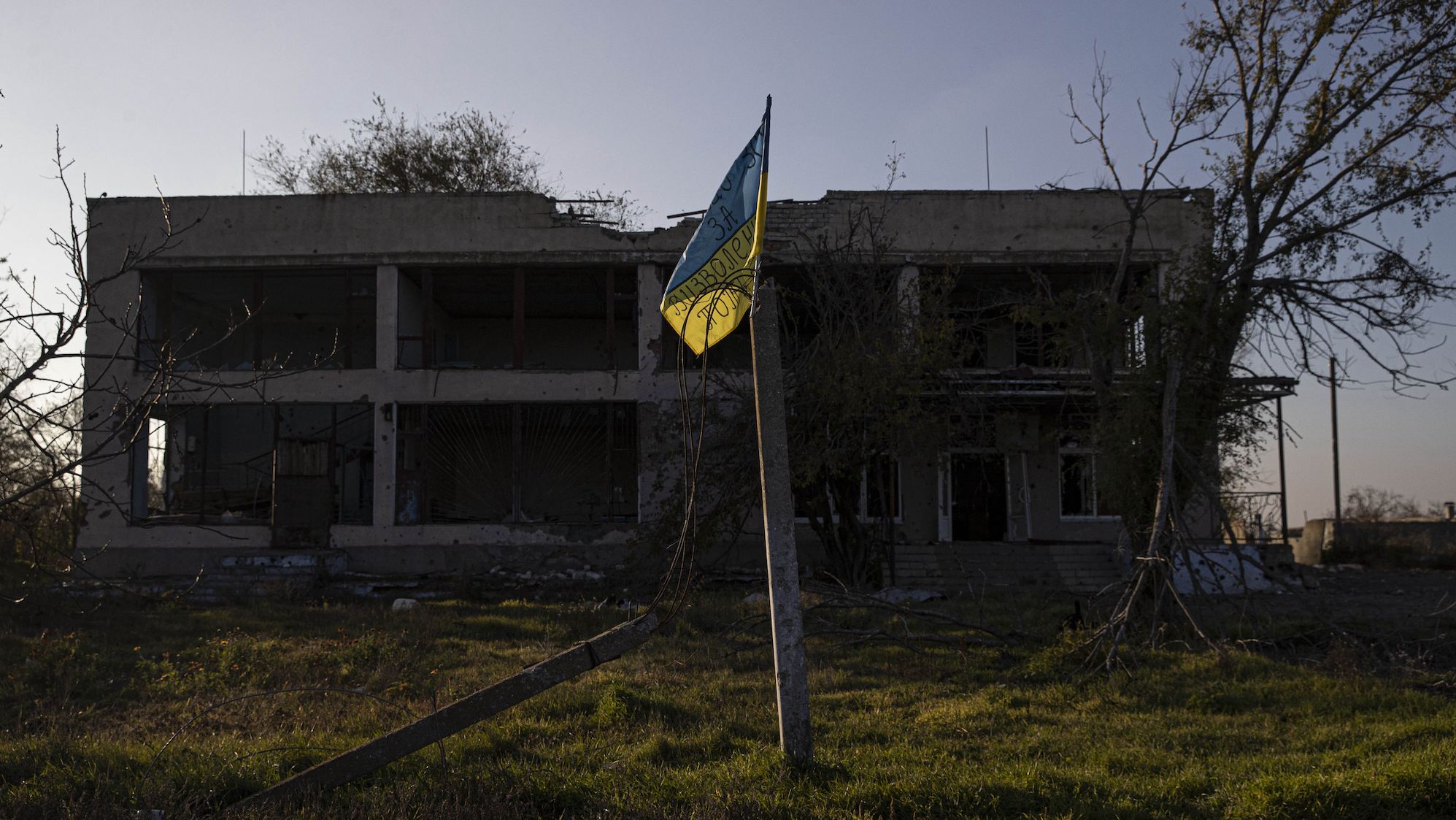 A view of the Ukrainian flag in front of a damaged settlement in Potemkin village which is recently retaken from Russian Forces, Kherson Oblast, Kherson, Ukraine on November 10, 2022. 