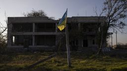 KHERSON OBLAST, UKRAINE - NOVEMBER 10: A view of the Ukrainian flag in front of a damaged settlement in Potemkin village which is recently retaken from Russian Forces, Kherson Oblast, Kherson, Ukraine on November 10, 2022. (Photo by Metin Aktas/Anadolu Agency via Getty Images)