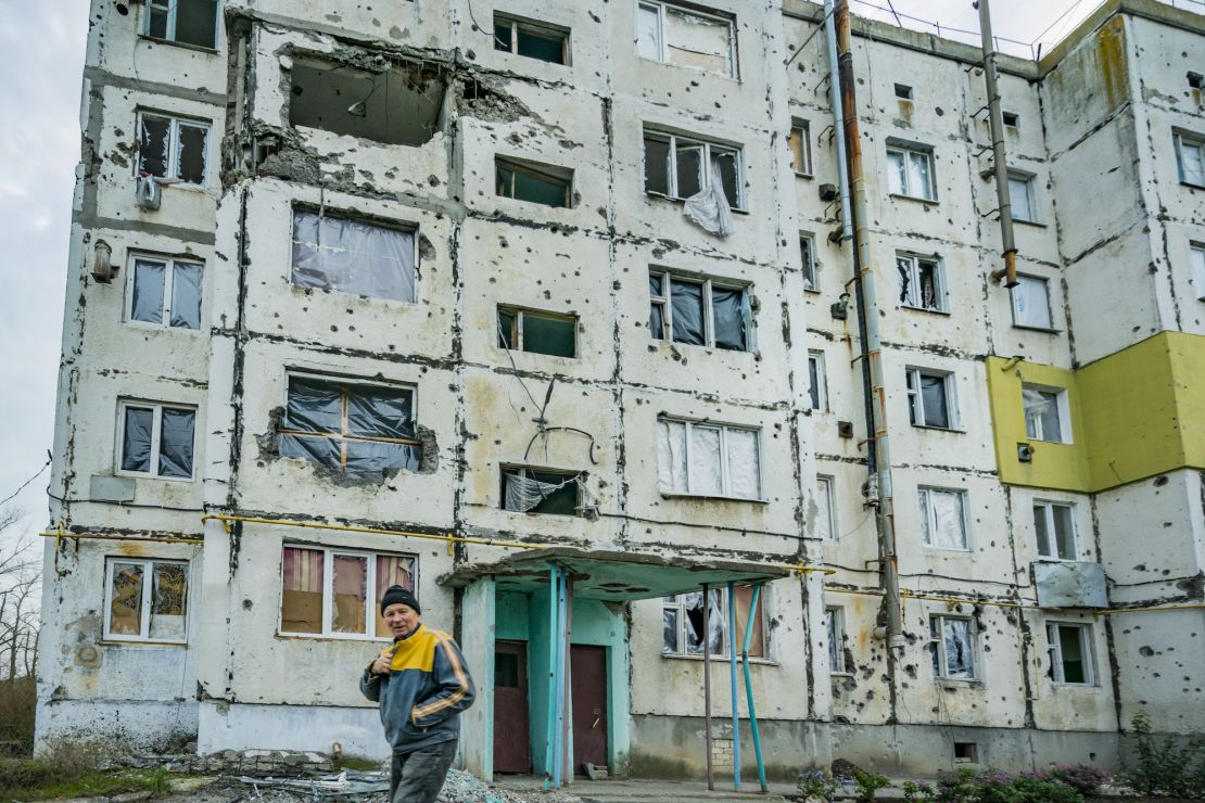 A local walks under a destroyed building in Vysokopillya, Kherson province, Ukraine. Nov. 11, 2022 