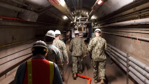 Navy and civilian water quality recovery experts are led through the tunnels of the Red Hill Bulk Fuel Storage Facility, near Pearl Harbor, Hawaii, in December 2021.