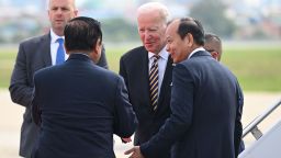 US President Joe Biden (C) is greeted by Cambodian officials upon arrival in Phnom Penh International Airport on November 12, 2022, as he travels to attend the 2022 Association of Southeast Asian Nations (ASEAN) Summit. 