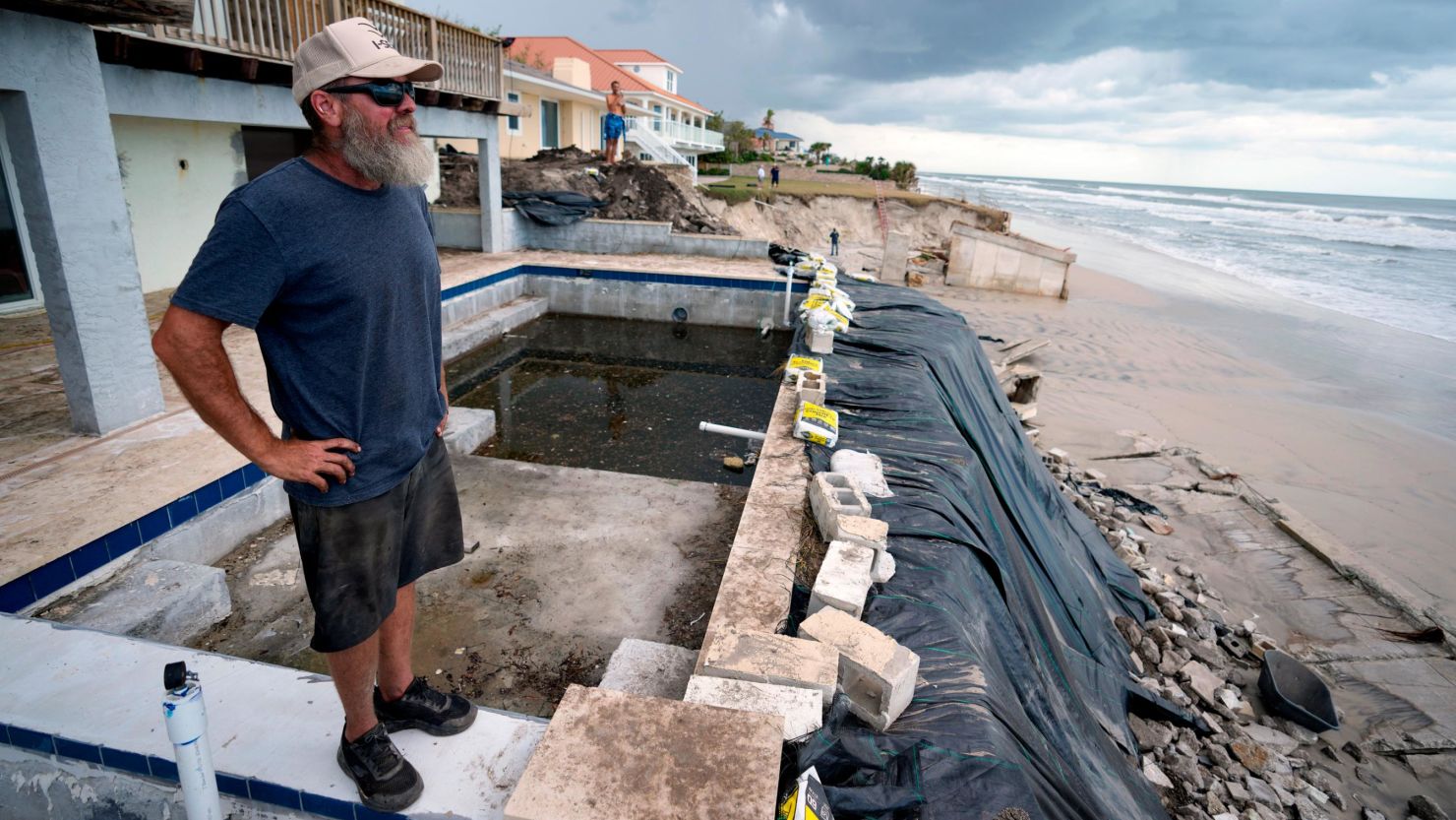 Josh Wagner at his family's home, where he and friends have been shoring up a system of reinforcement that he designed the day before after his seawall collapsed, in an effort to save his home following the passage of Nicole, Friday, Nov. 11, 2022, in Ponce Inlet, Fla. 
