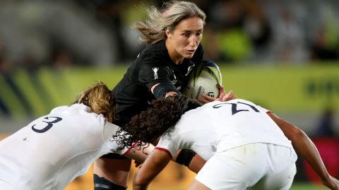 New Zealand's Sarah Hirini (C) is tackled by England's Sadia Gabea (R) and Sarah Byrne.