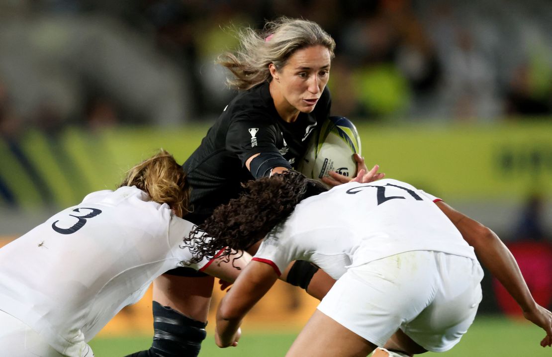 New Zealand's Sarah Hirini (C) is tackled by England's Sadia Kabeya (R) and Sarah Bern.