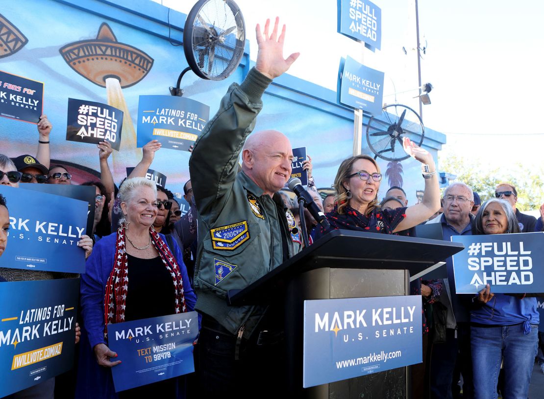 Arizona Sen. Mark Kelly, here with his wife, former US Rep. Gabby Giffords, declares victory in his reelection race at a rally in Phoenix on November 12, 2022. 