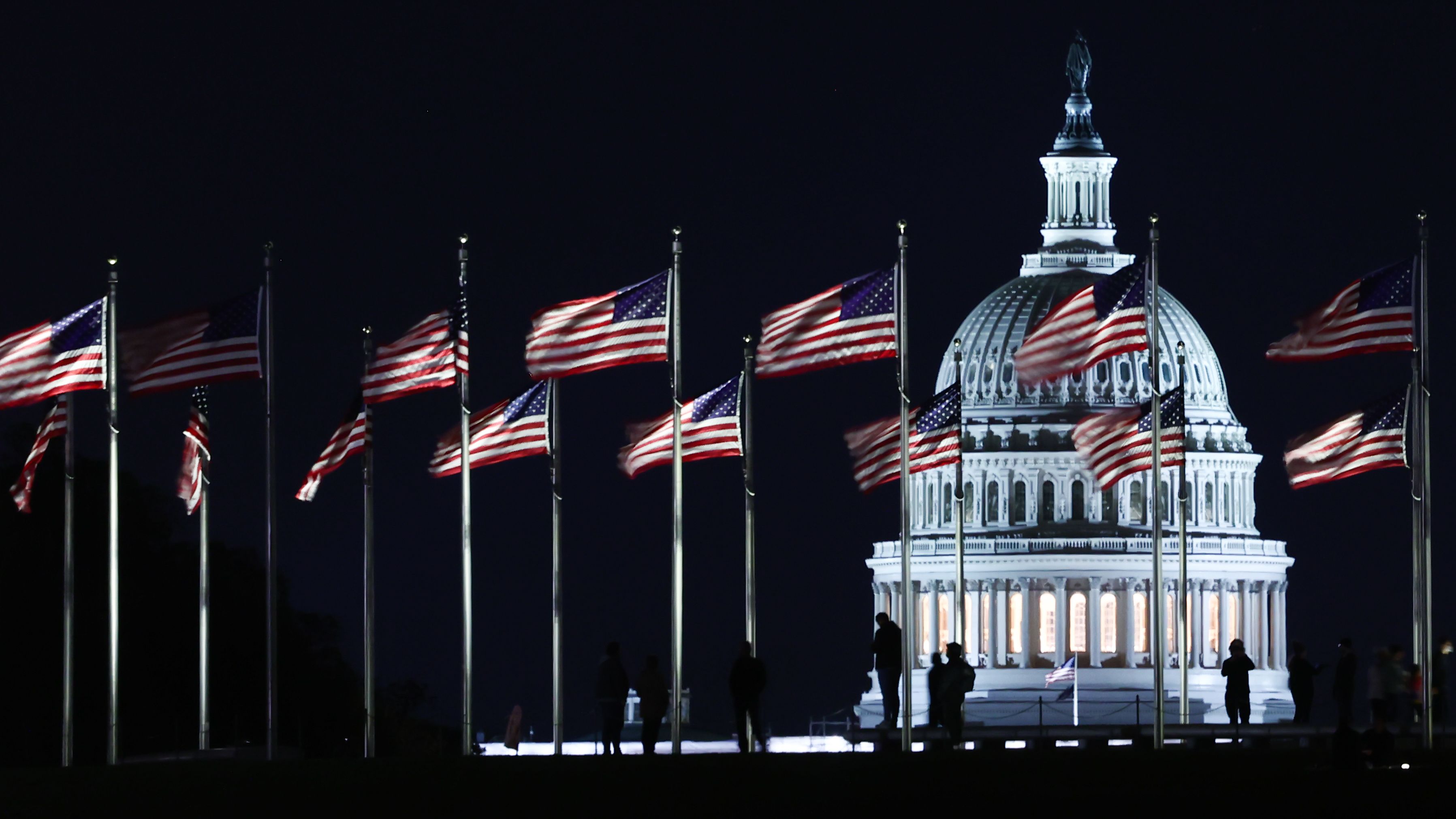 The Capitol building is seen through the American flags in Washington DC on October 20, 2022. 